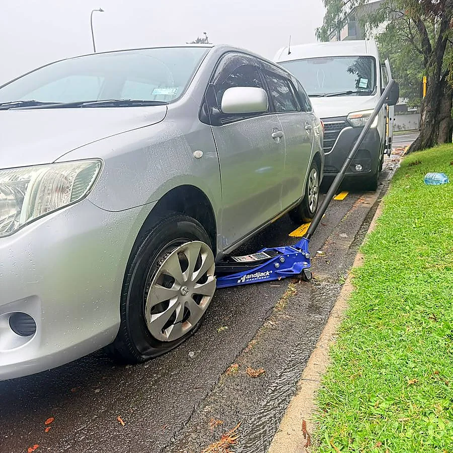 Roadside tyre assistance during wet Auckland weather