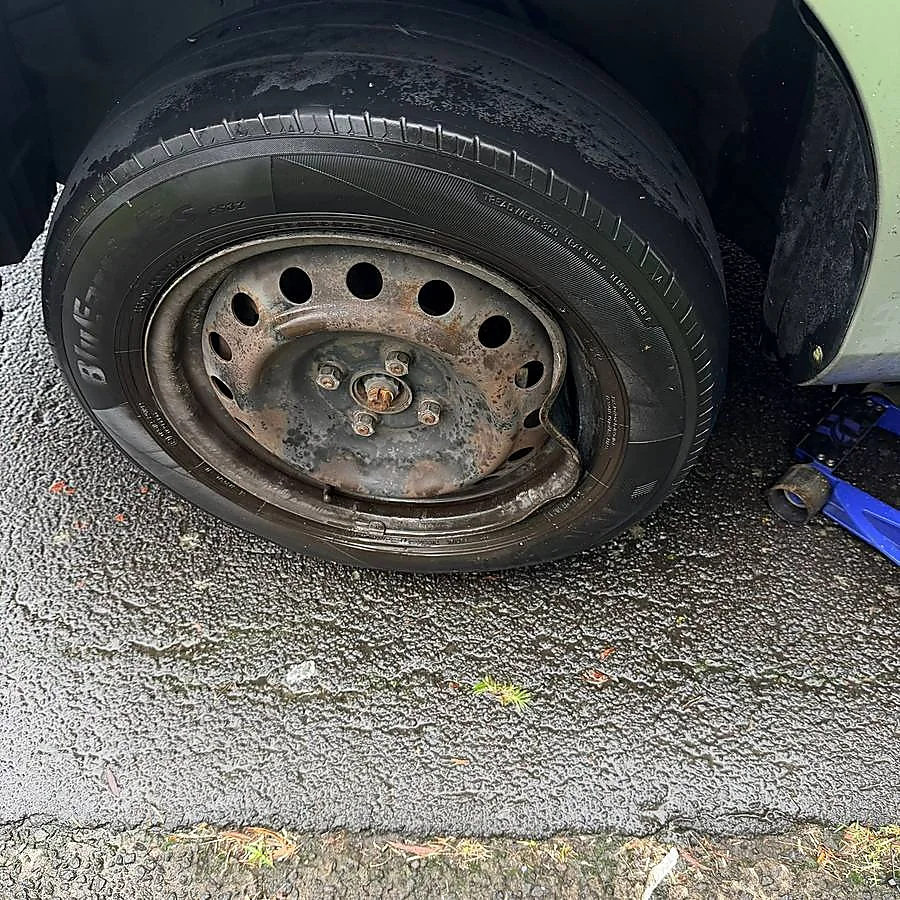 Close-up of a damaged tyre being inspected